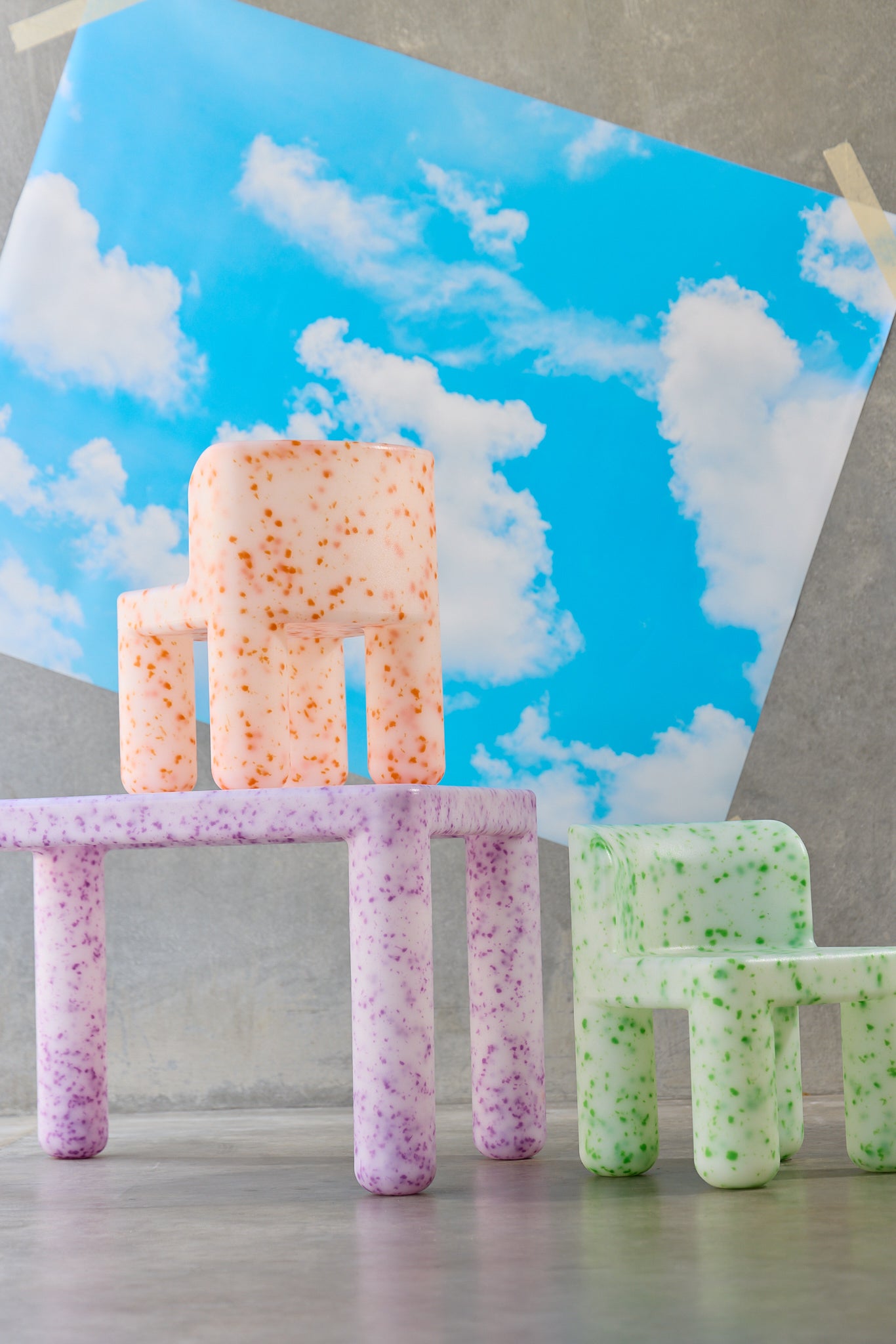 Colorful foam letters spelling 'SMILE' against a blue sky with clouds background